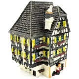 White Alsatian corner house with half-timbering in resin