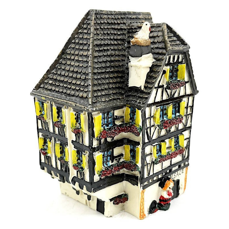 White Alsatian corner house with half-timbering in resin