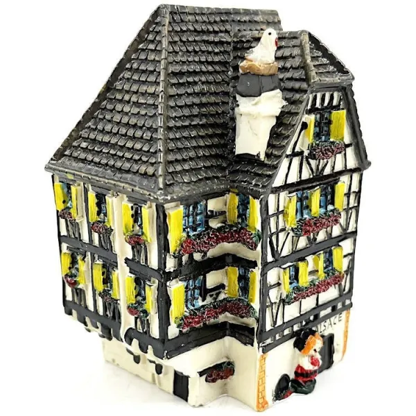 White Alsatian corner house with half-timbering in resin