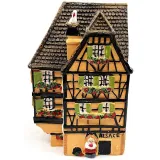 Orange Alsatian corner house with half-timbering in resin