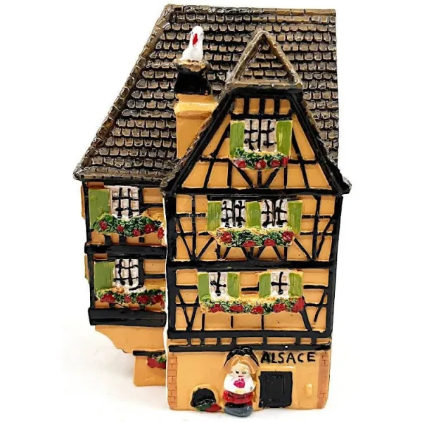 Orange Alsatian corner house with half-timbering in resin