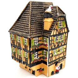 Orange Alsatian corner house with half-timbering in resin