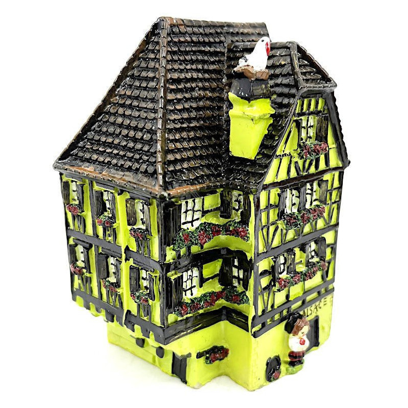 Green Alsatian corner house with half-timbering in resin