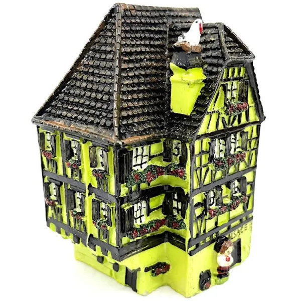 Green Alsatian corner house with half-timbering in resin