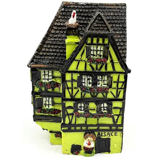 Green Alsatian corner house with half-timbering in resin