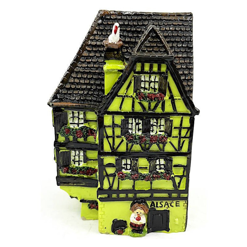 Green Alsatian corner house with half-timbering in resin