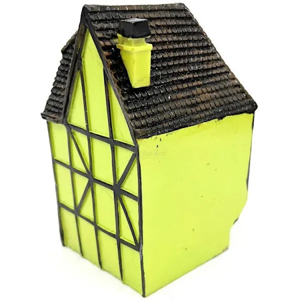 Green Alsatian corner house with half-timbering in resin