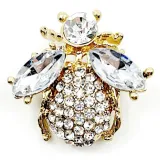 Fancy gold brooch with flying insect and rhinestones