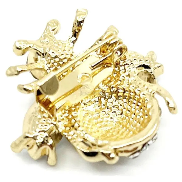 Fancy gold brooch with flying insect and rhinestones