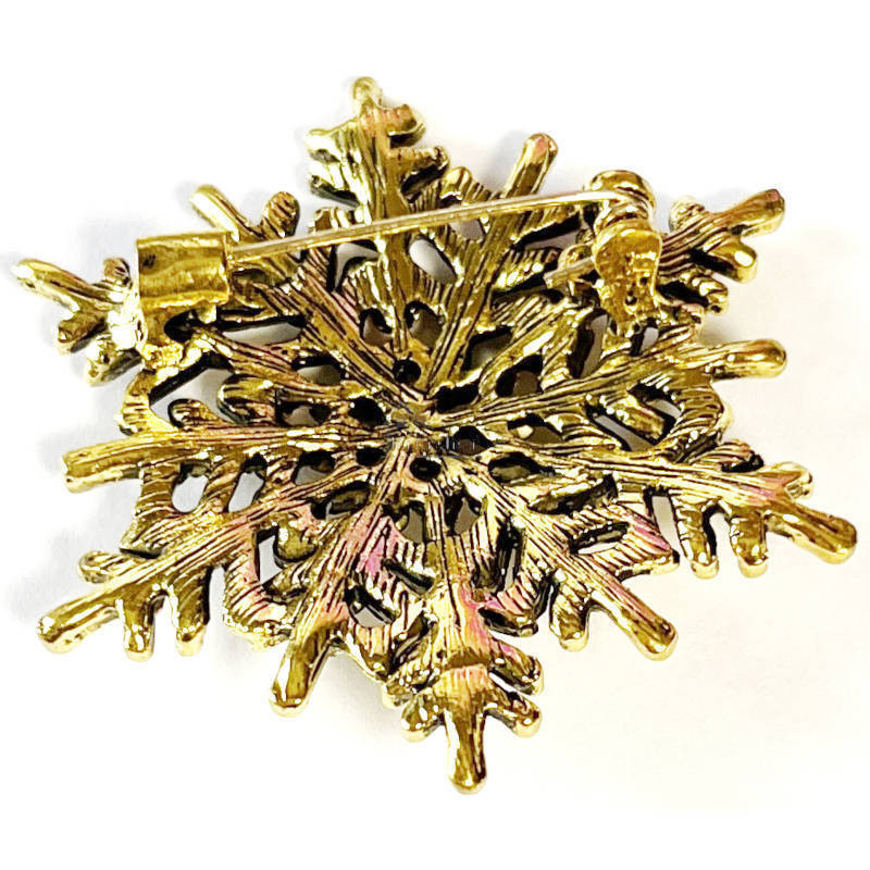 Goldfarbene Fantasie-Brosche mit Schneeflocke und Strasssteinen
