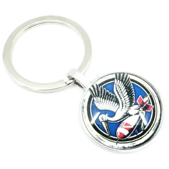 Porte Clé Cigogne en vol sur fusée