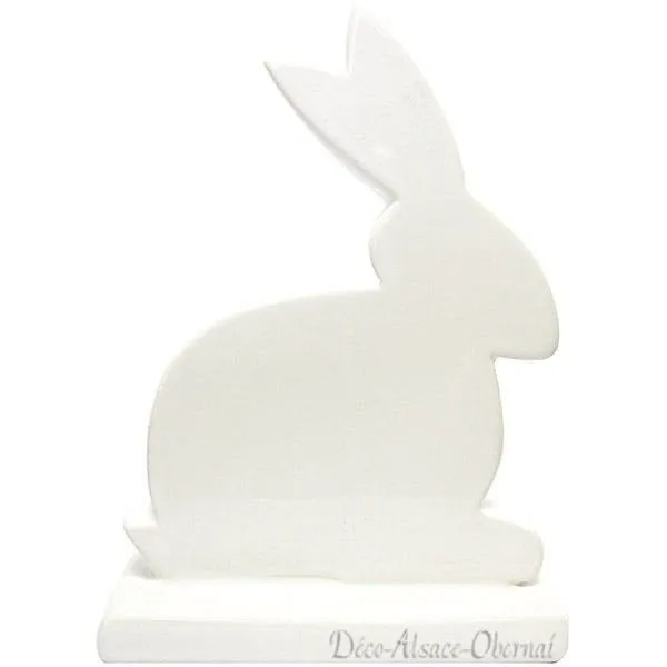 Decorative rabbit sitting on a white ceramic base