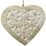 Solid wood heart carved on a white background decorated with mirrors
