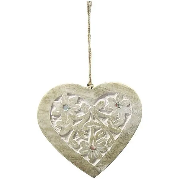 Solid wood heart carved on a white background decorated with mirrors
