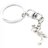 Metal Keyring Charm with an Alsatian Stork carrying a baby