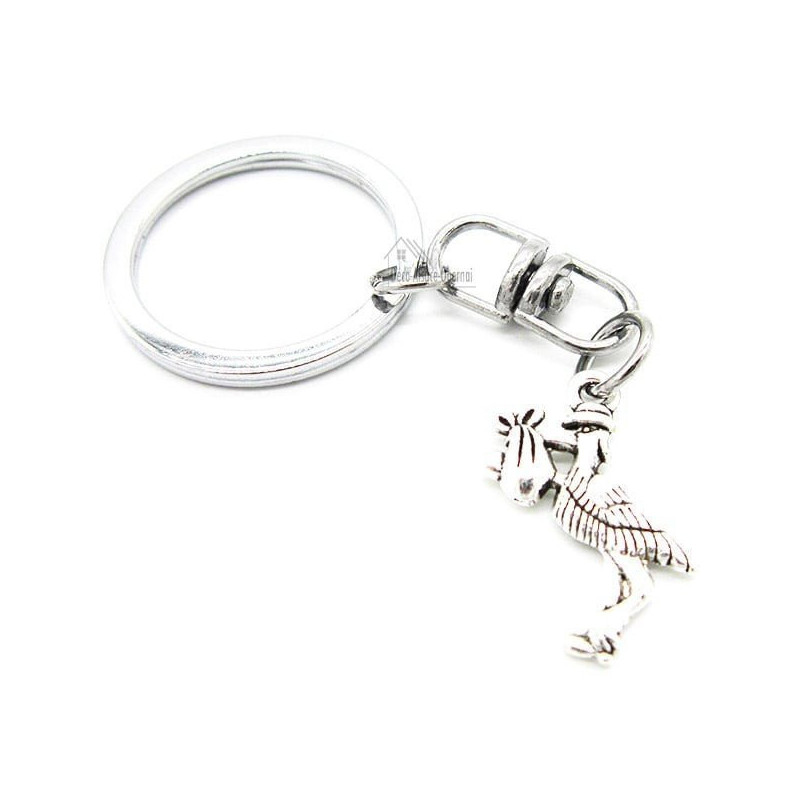 Metal Keyring Charm with an Alsatian Stork carrying a baby