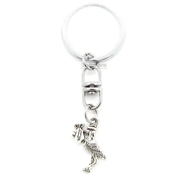 Metal Keyring Charm with an Alsatian Stork carrying a baby