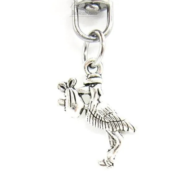 Metal Keyring Charm with an Alsatian Stork carrying a baby