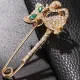 Broche Épingle à Nourrice Fantaisie dorée forme Chat yeux verts sertie de Strass