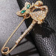 Fancy golden safety pin brooch cat shape green eyes set with rhinestones