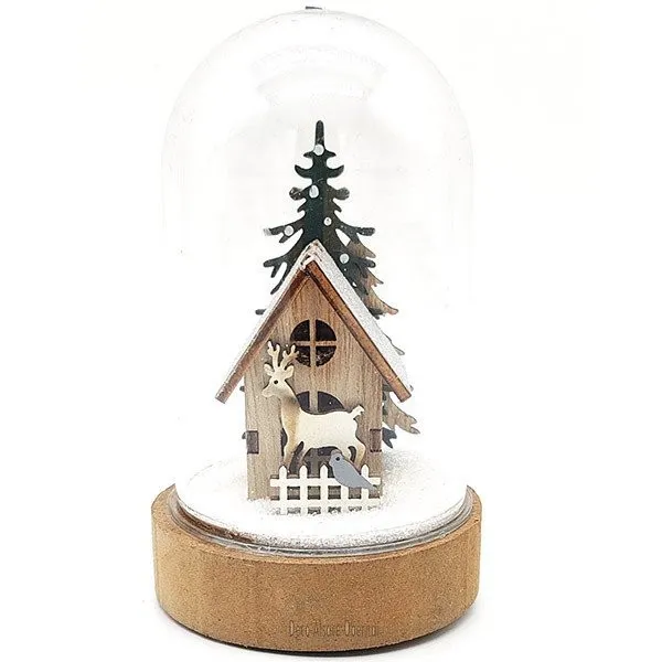 Christmas scene under a bell with House illuminated with Led lights