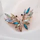 Broche dorée Fantaisie forme de Papillon en vol sertie de Strass