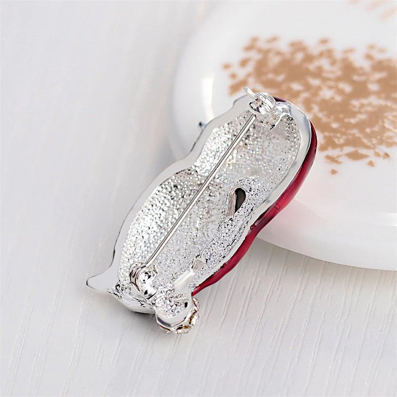 Fancy golden brooch Penguin red cap set with rhinestones