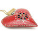 Red metal heart with openwork center and handmade decoration