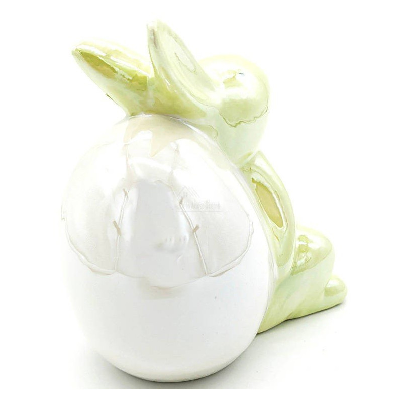 Green Ceramic Rabbit sitting against an Egg